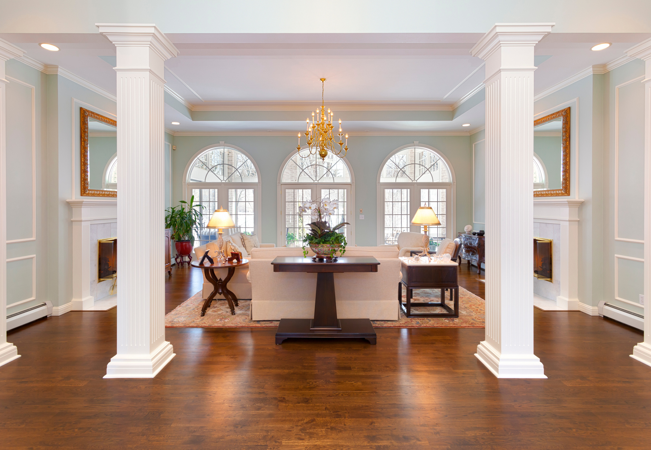 Grand Foyer and Living Room With White Pillars, Half-Round Windows